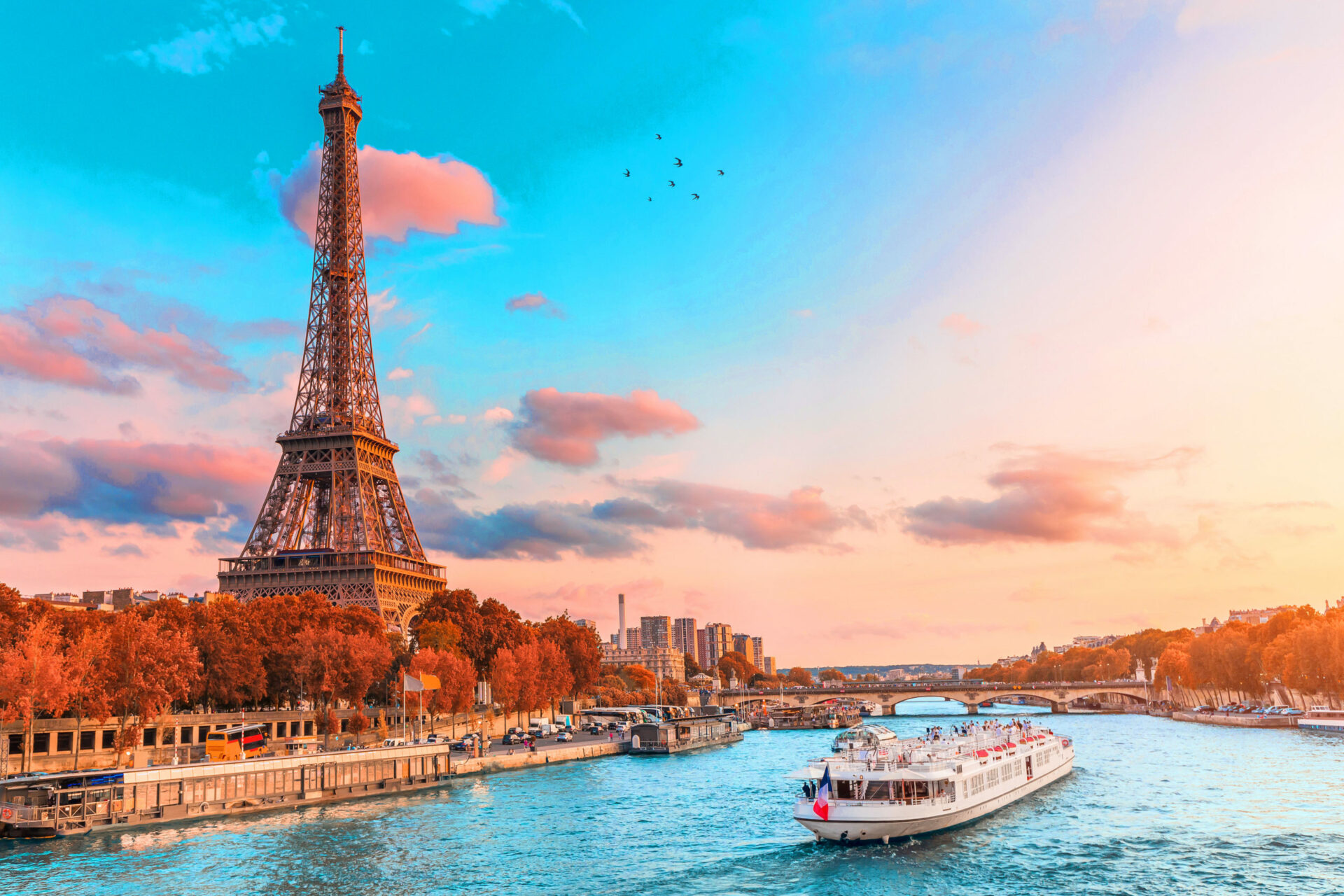 The main attraction of Paris and all of Europe is the Eiffel tower in the rays of the setting sun on the bank of Seine river with cruise tourist ships Helsinki